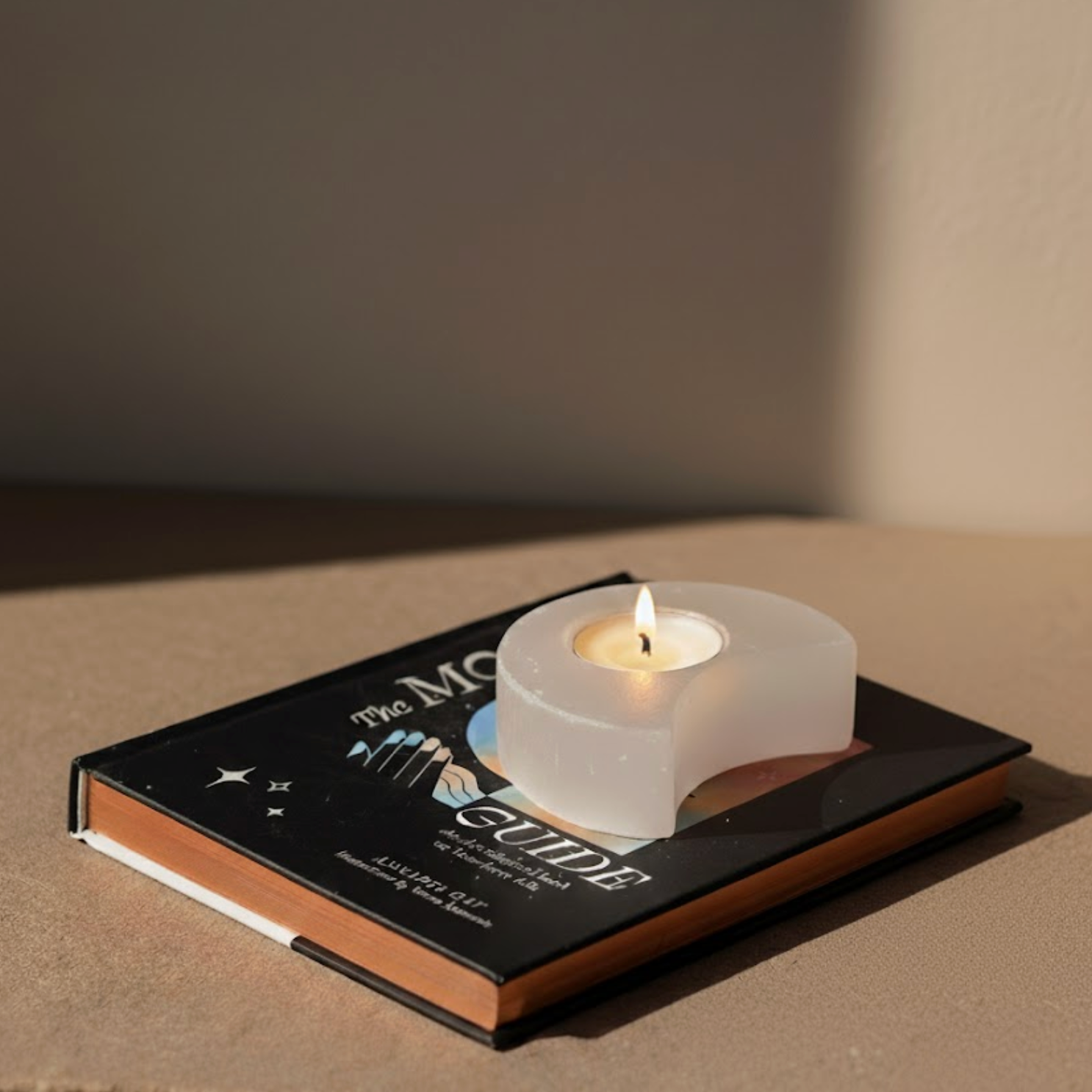 Selenite Moon Candle Holder glowing with warm light — winter solstice crystals