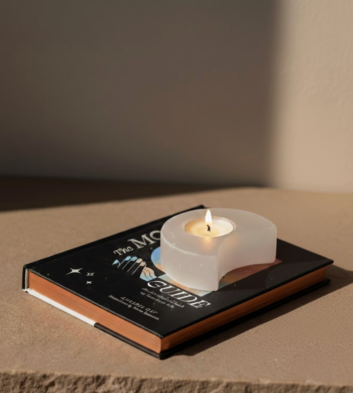 Selenite Moon Candle Holder glowing with warm light — winter solstice crystals