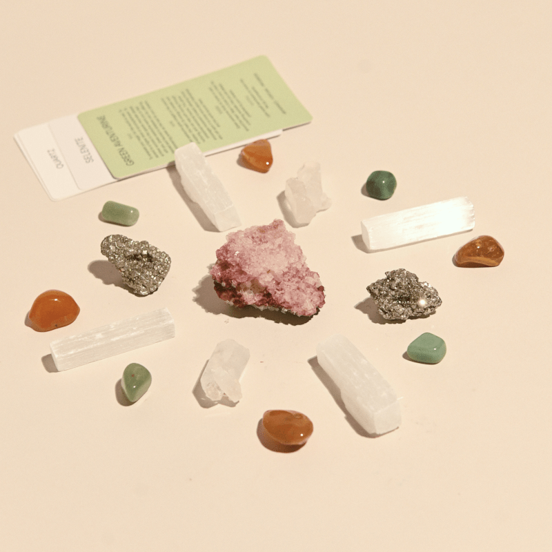 Crystal grid kit with rose quartz, amethyst, and clear quartz arranged in sacred geometry pattern