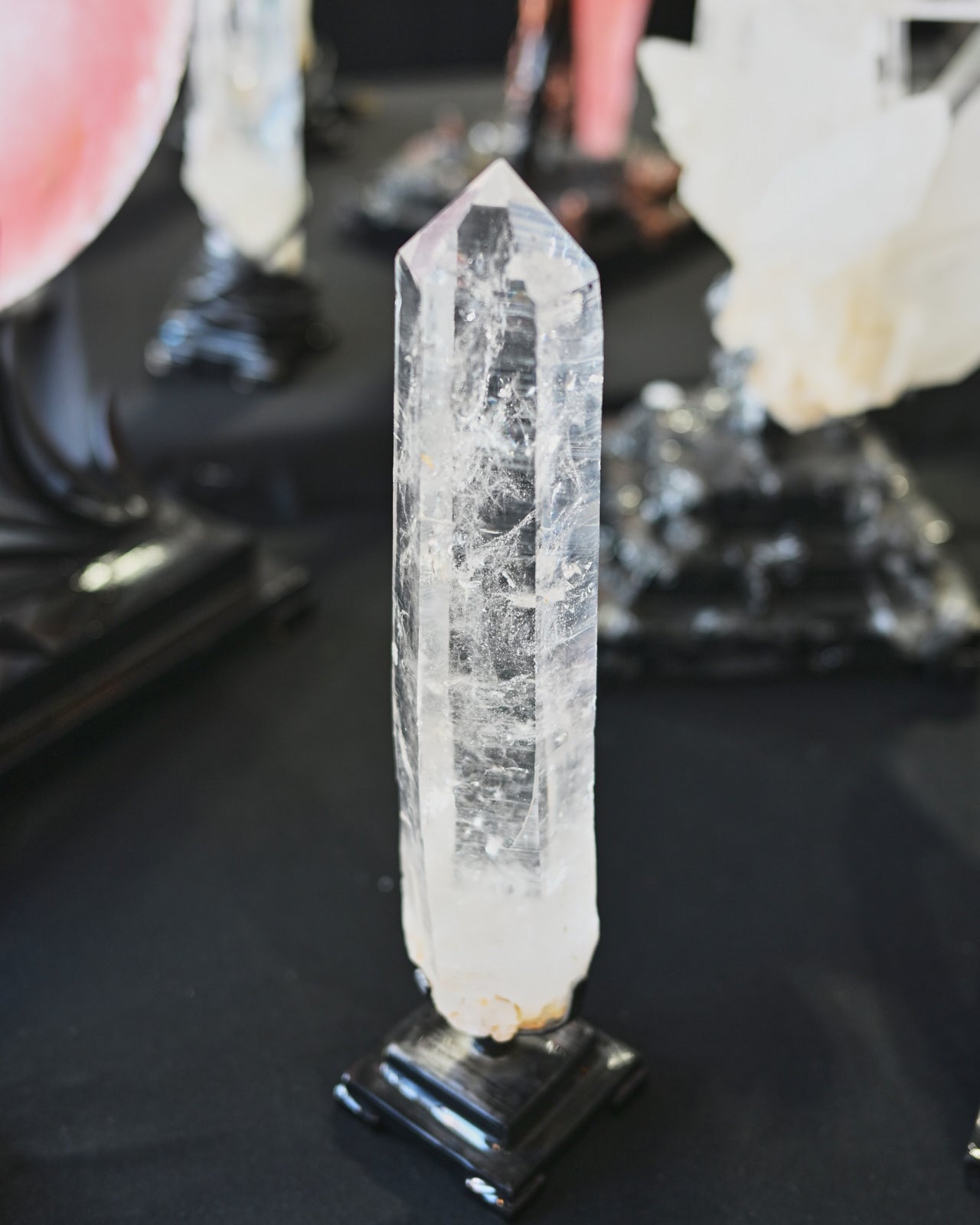 Clear crystal on a black stand with blurred background
