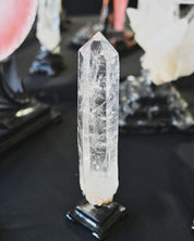 Clear crystal on a black stand with blurred background