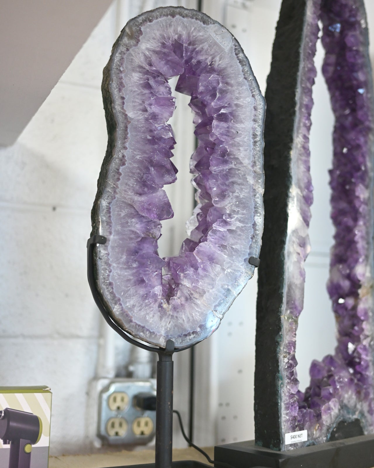 Amethyst geode on a stand with a blurred background
