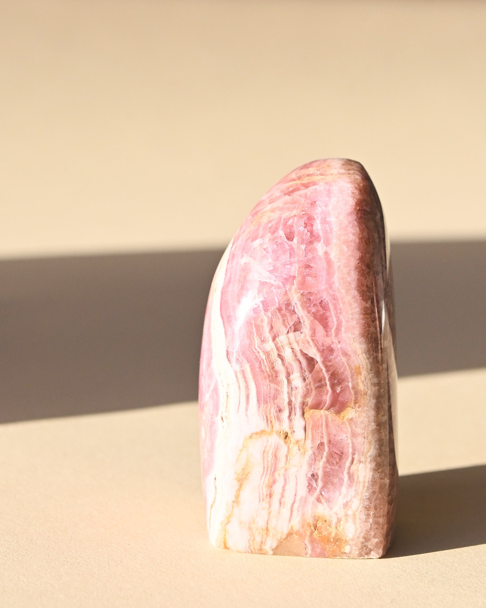 Rhodochrosite Polished Freeform - pyrite crystal freeform sculpture in natural light