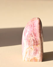 Rhodochrosite Polished Freeform - pyrite crystal freeform sculpture in natural light