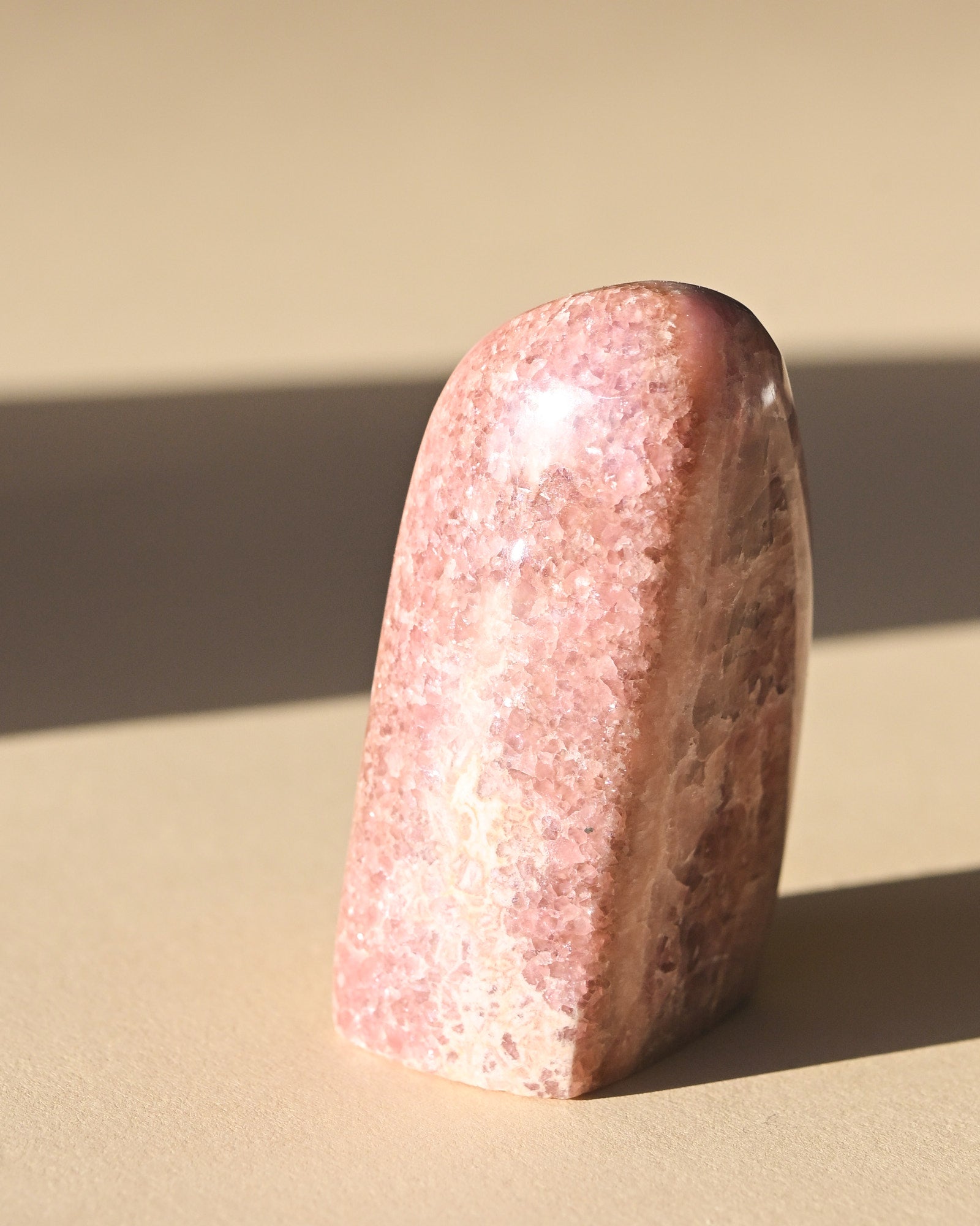 Rhodochrosite Polished Freeform - pyrite crystal freeform sculpture styled in home