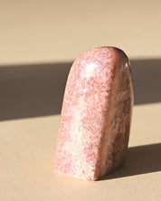 Rhodochrosite Polished Freeform - pyrite crystal freeform sculpture styled in home