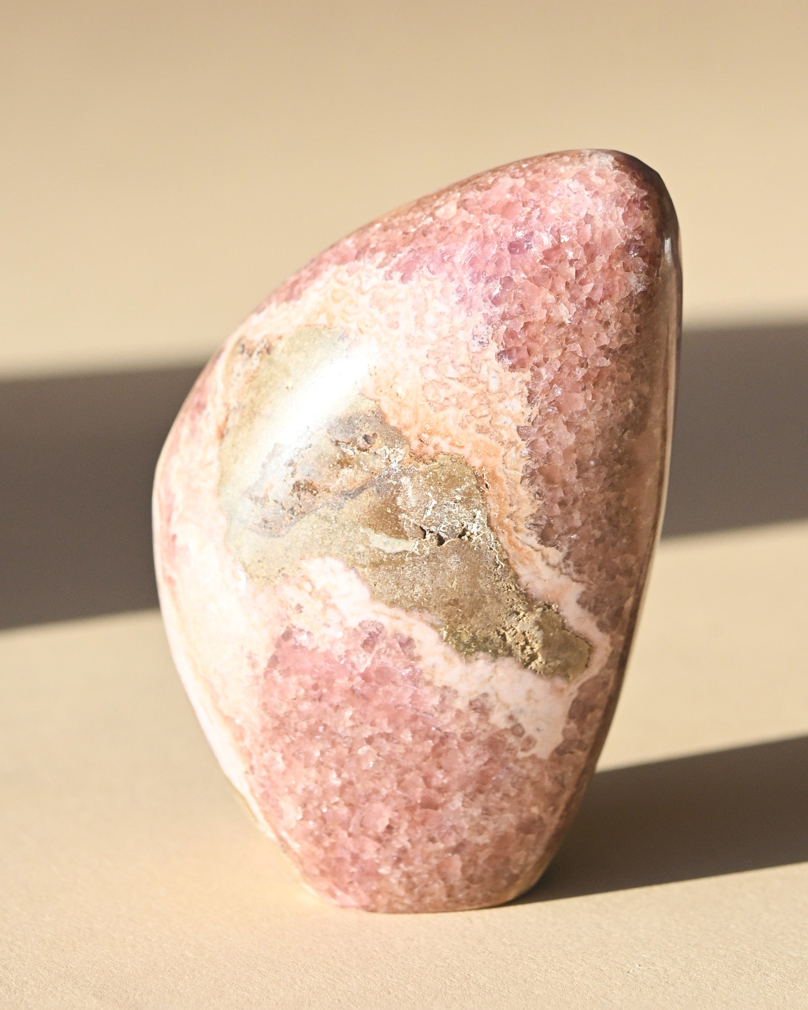 Rhodochrosite Polished Freeform 3in - pyrite crystal freeform sculpture in natural light
