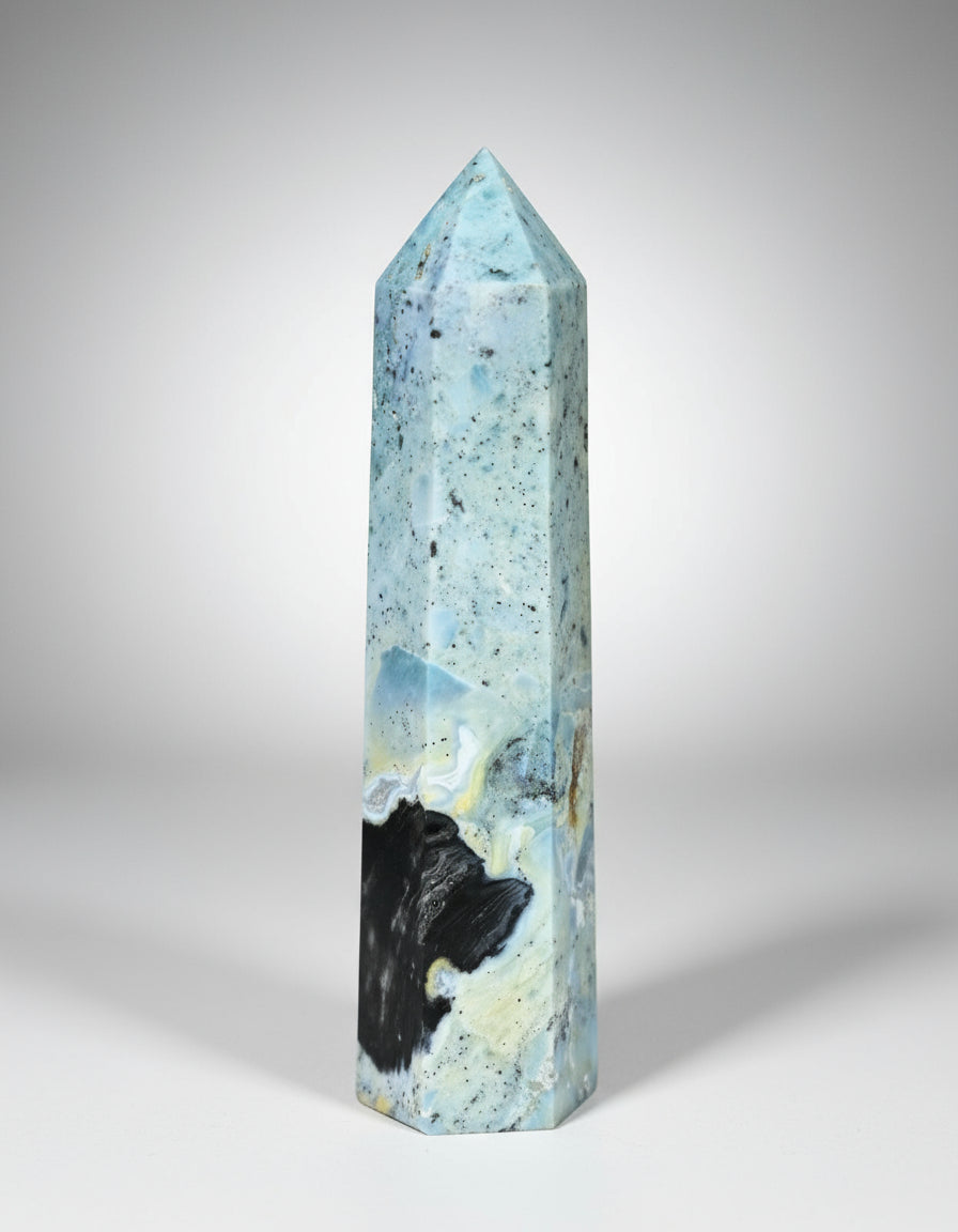 Crystal tower on a black surface with a blurred background