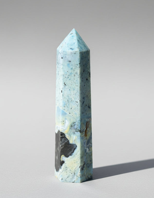 Marble-like obelisk on a gray background