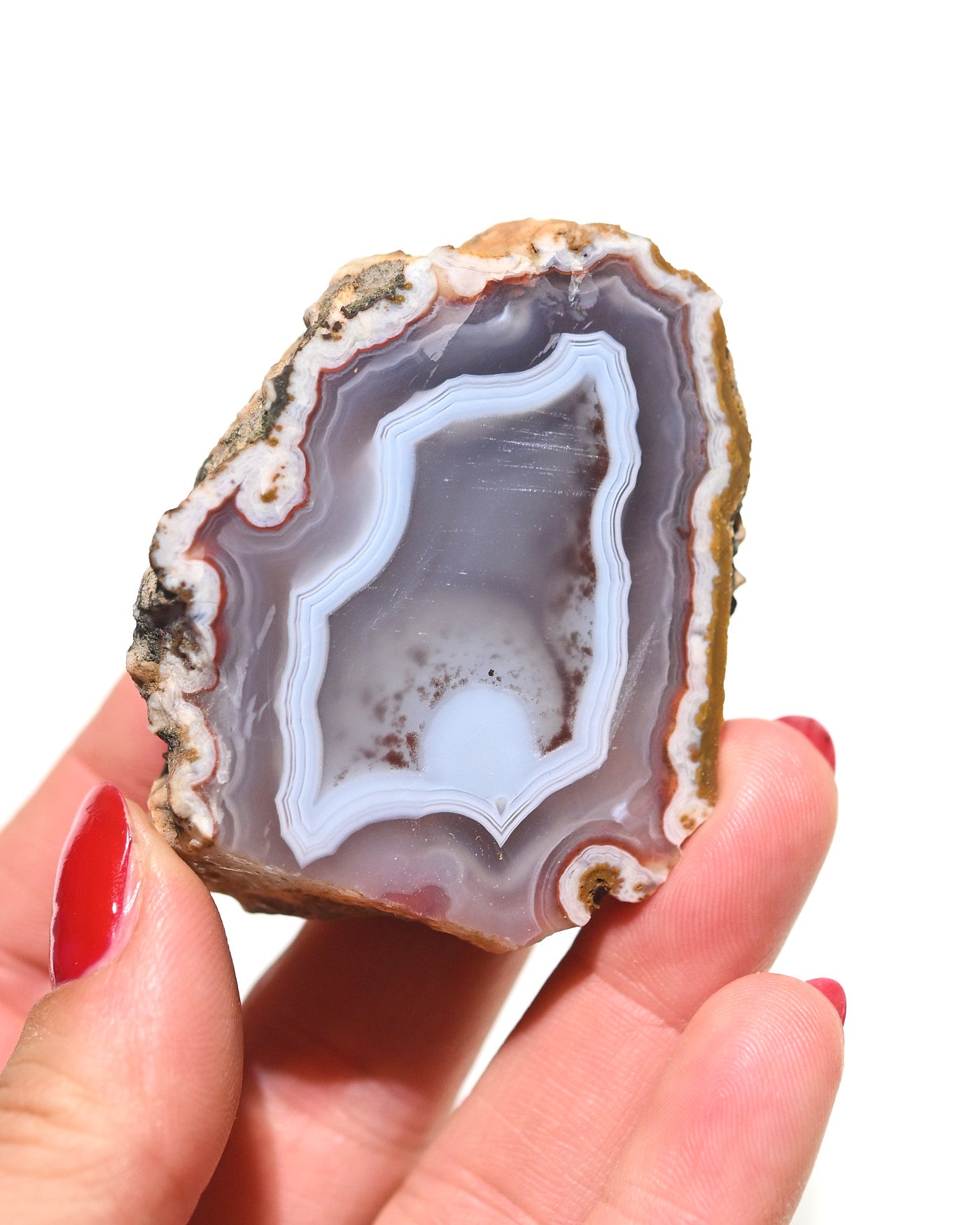 Moroccan agate geode held in hand for scale