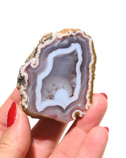 Moroccan agate geode held in hand for scale
