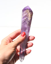 Amethyst double terminated point held in hand