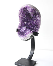 Deep purple amethyst geode on sculptural metal stand
