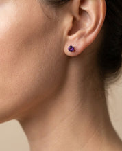 Amethyst stud earrings in sterling silver worn on model