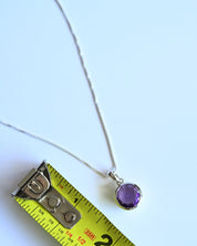 Amethyst Pendant size reference — approximately 1/2 inch diameter