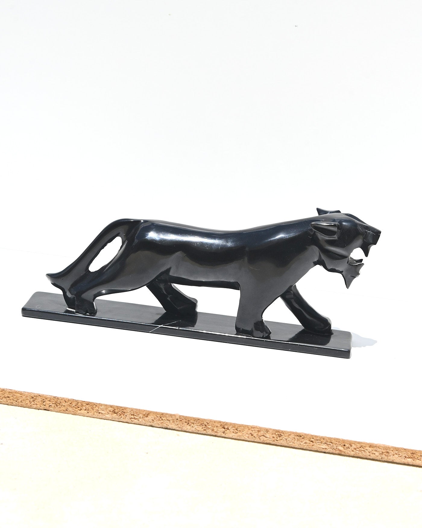 Hand-carved black onyx panther side profile showing polished surface