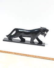 Hand-carved black onyx panther side profile showing polished surface