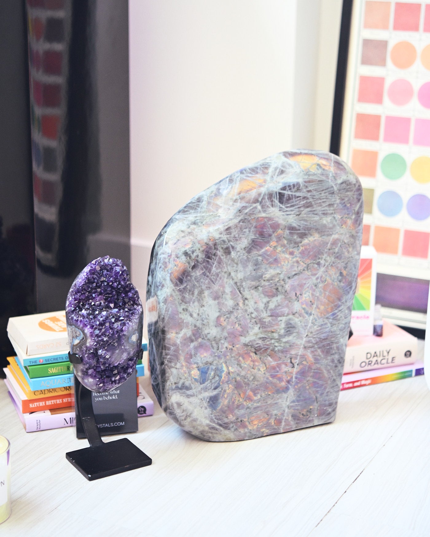 Amethyst geode on stand next to large labradorite freeform - curated bundle