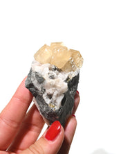 Calcite crystal cluster side view showing rhombohedral cleavage