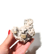 Calcite with Dolomite specimen from Canada held in hand