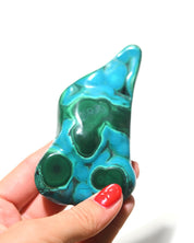 Chrysocolla Malachite freeform held in hand for scale