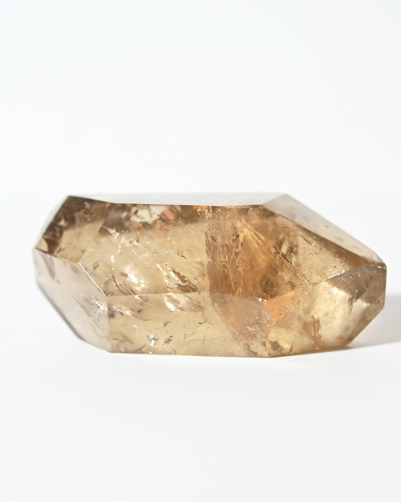 Natural smoky citrine point angled view showing amber tones