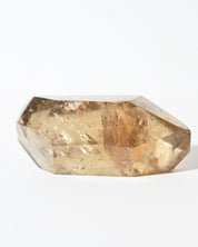 Natural smoky citrine point angled view showing amber tones