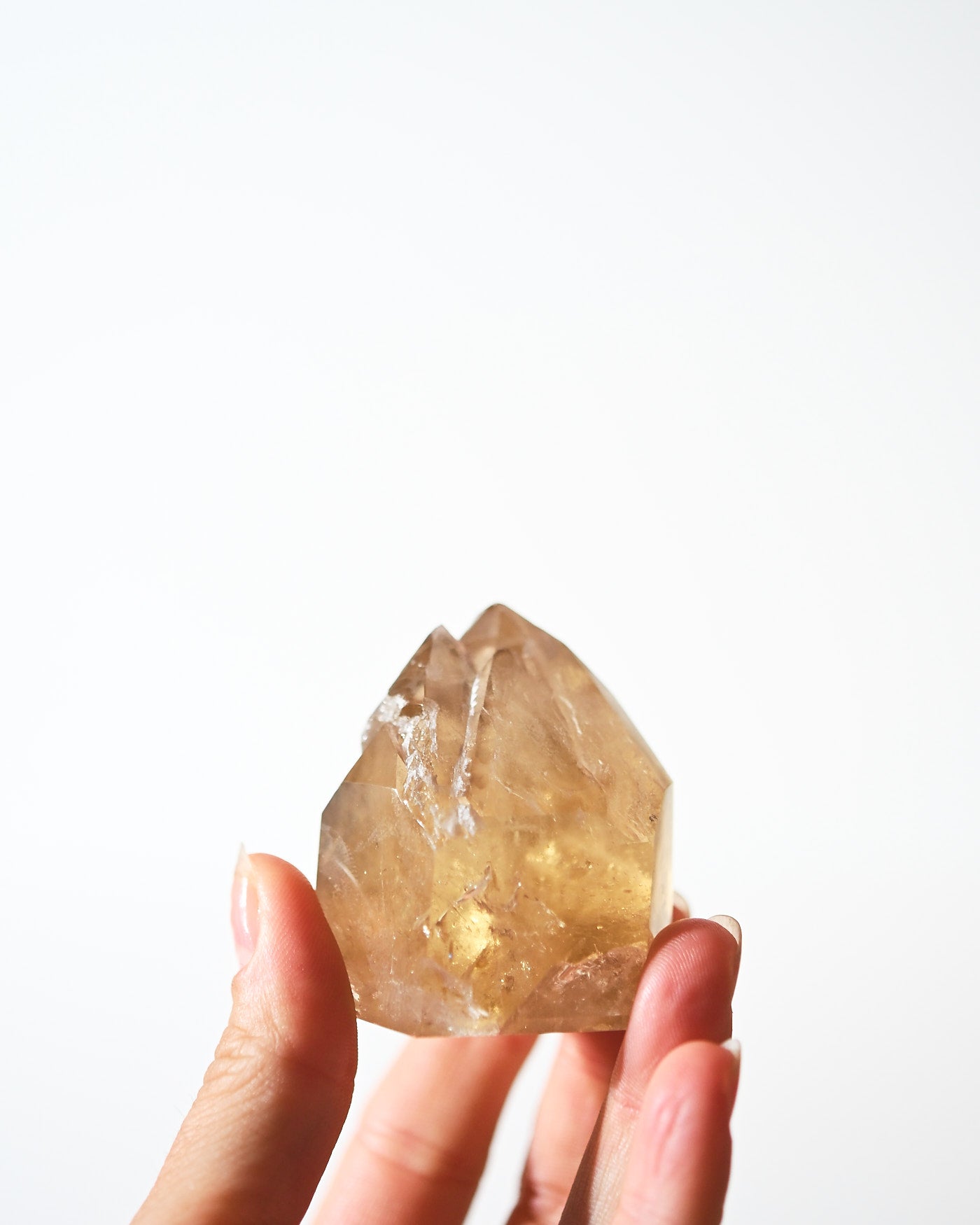 Citrine Twin Point Tower 114g in hand