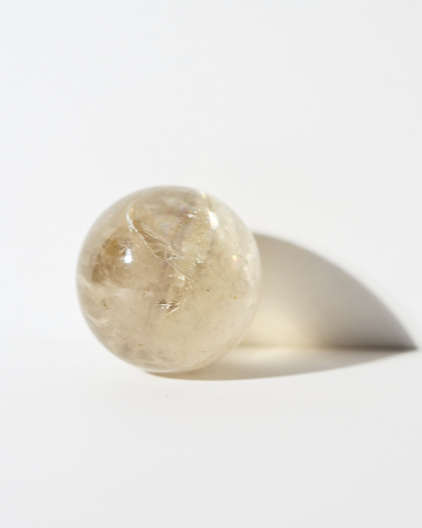 Citrine Sphere 115g backlit in hand