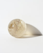 Citrine Sphere 115g backlit in hand