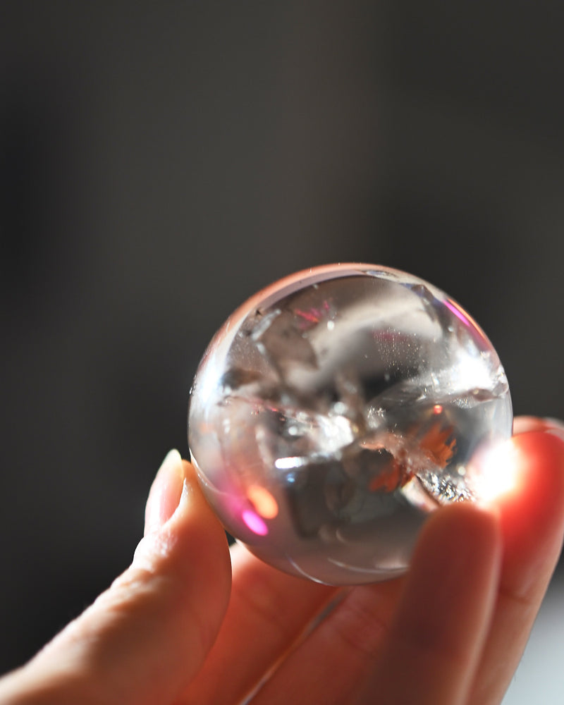 Smoky Citrine Sphere 160g in hand with rainbow