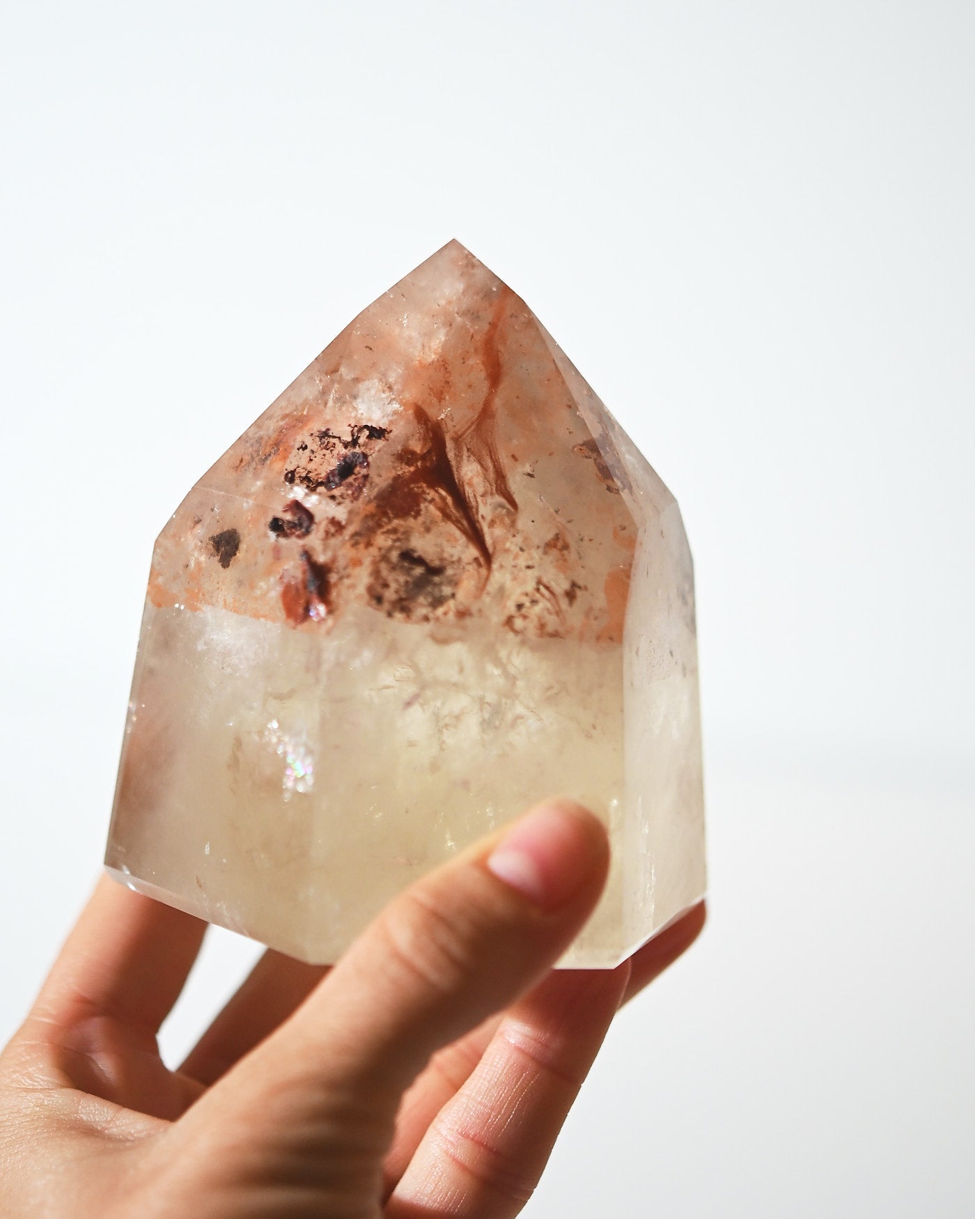 Natural citrine tower with iron oxide inclusions, 670g, hand-held view