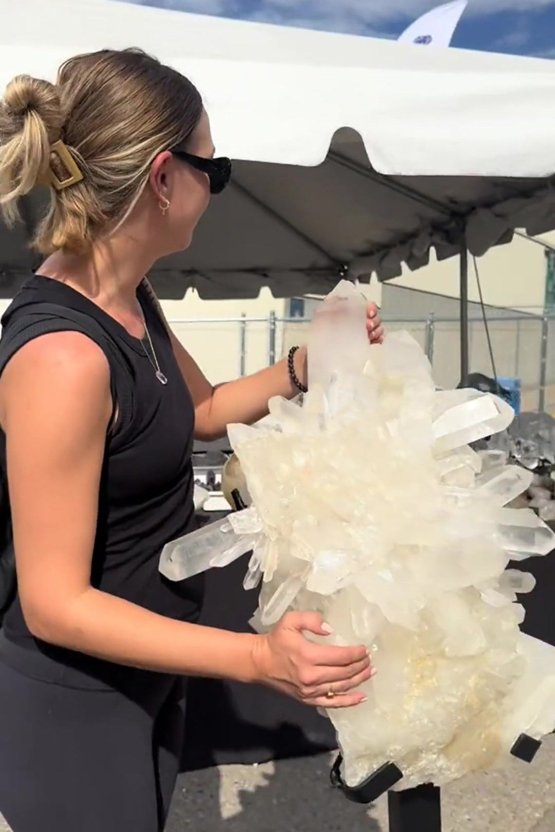 Brittany inspecting a quartz cluster at the Denver Gem Show