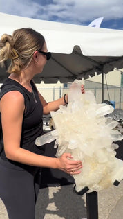 Brittany inspecting a quartz cluster at the Denver Gem Show