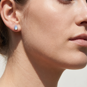 Rainbow Moonstone Teardrop Stud Earring worn on ear - Sterling Silver - Crystals.com
