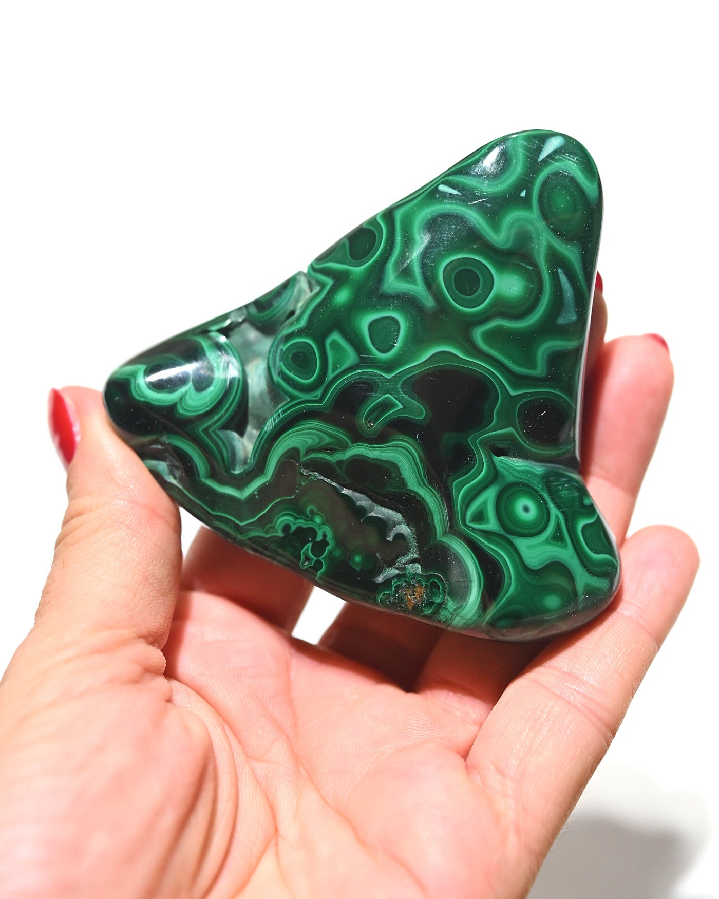 Malachite freeform in hand showing mirror polish