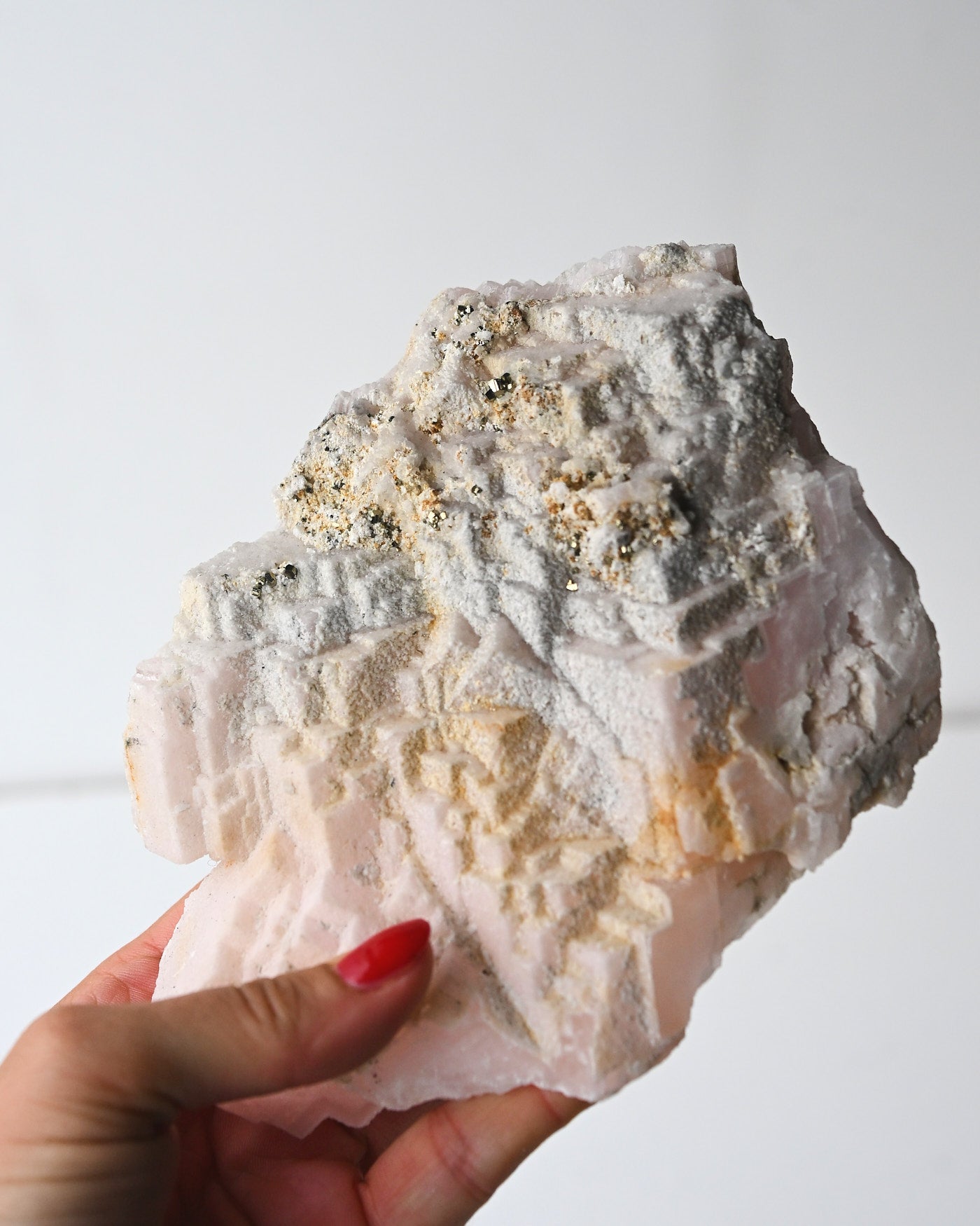 Manganoan calcite with pyrite held in hand
