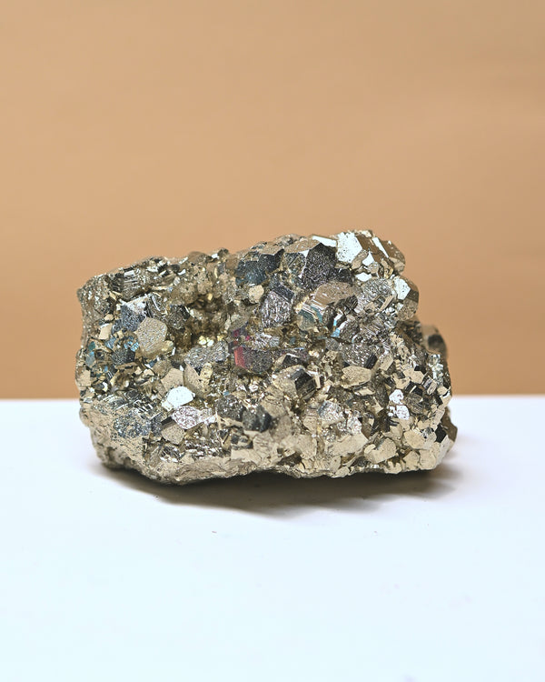 Mineral specimen on a white surface with a beige background