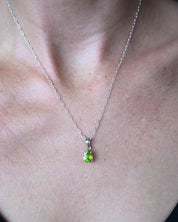 Natural peridot sterling silver pendant worn on model