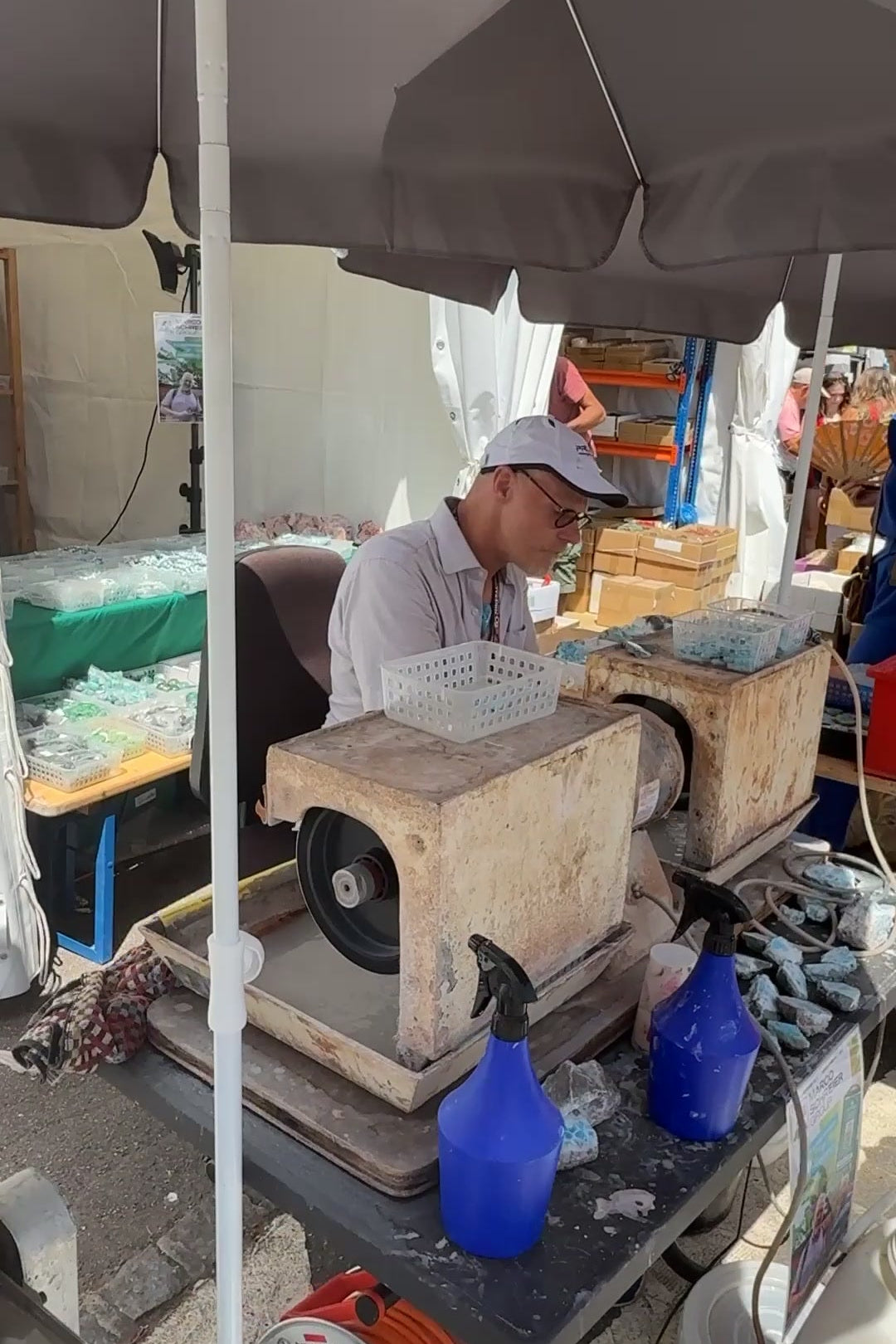 Lapidary cutting stone at the Sainte-Marie-aux-Mines gem show, June 2025