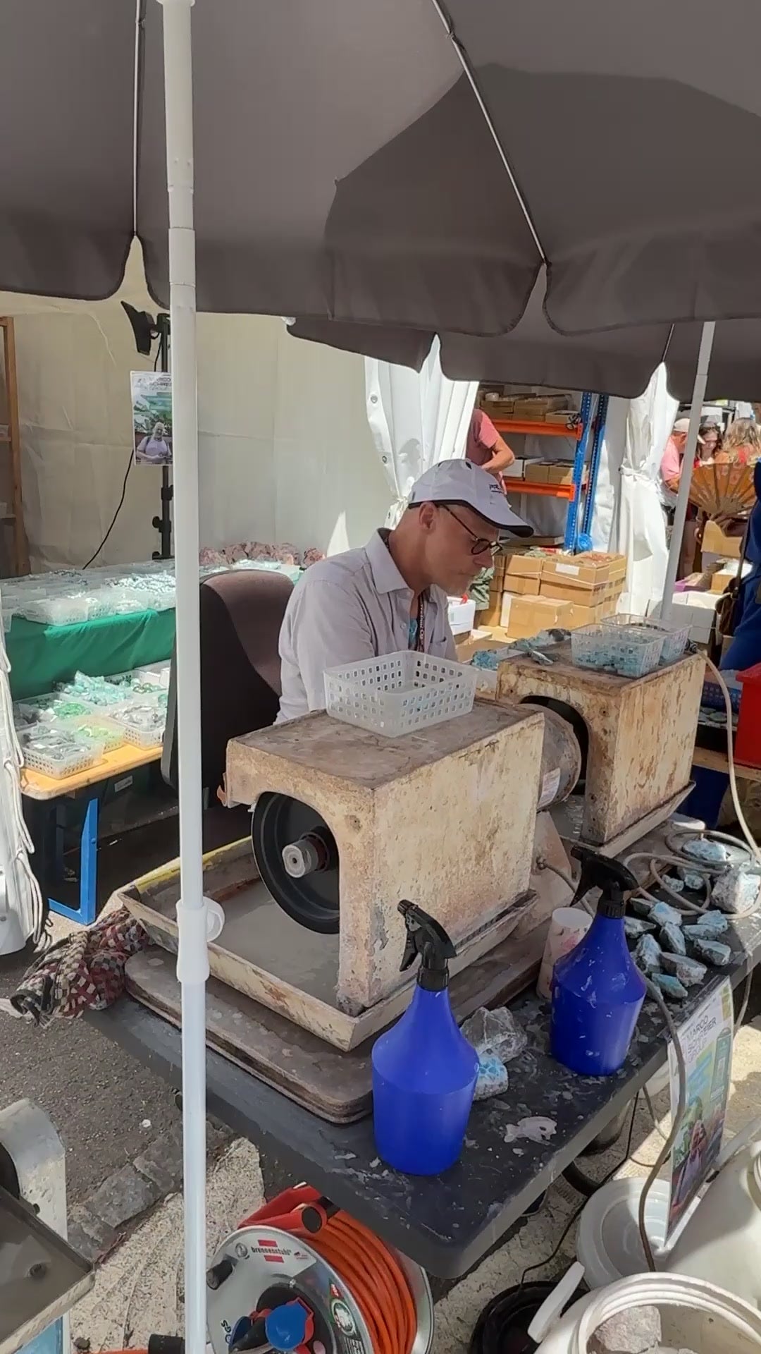 Lapidary cutting stone at the Sainte-Marie-aux-Mines gem show, June 2025