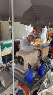 Lapidary cutting stone at the Sainte-Marie-aux-Mines gem show, June 2025