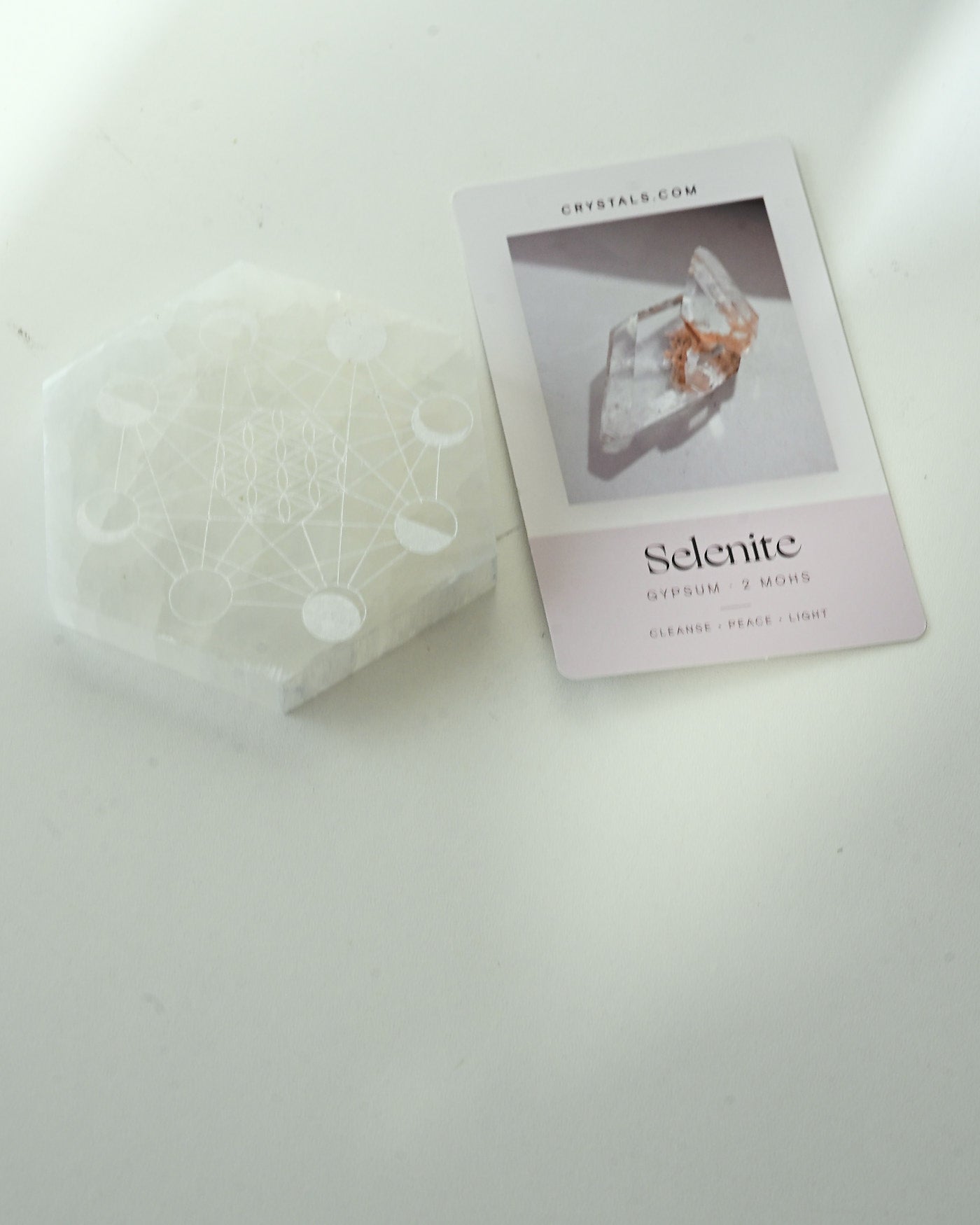 Selenite Moon Cycle Plate flat lay with crystal info card