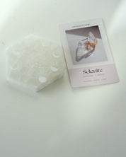 Selenite Moon Cycle Plate flat lay with crystal info card