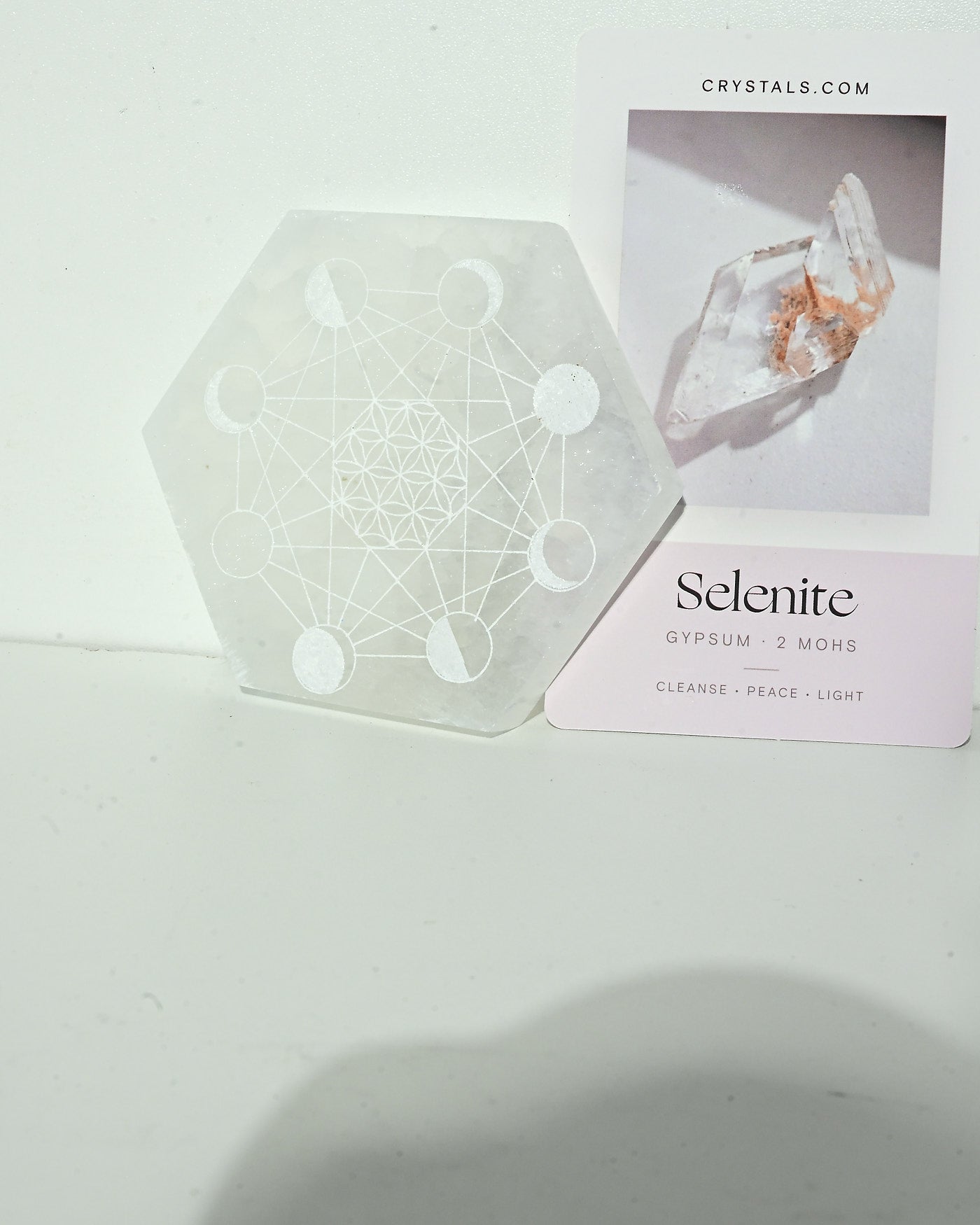 Selenite Moon Cycle Plate standing with Crystals.com card