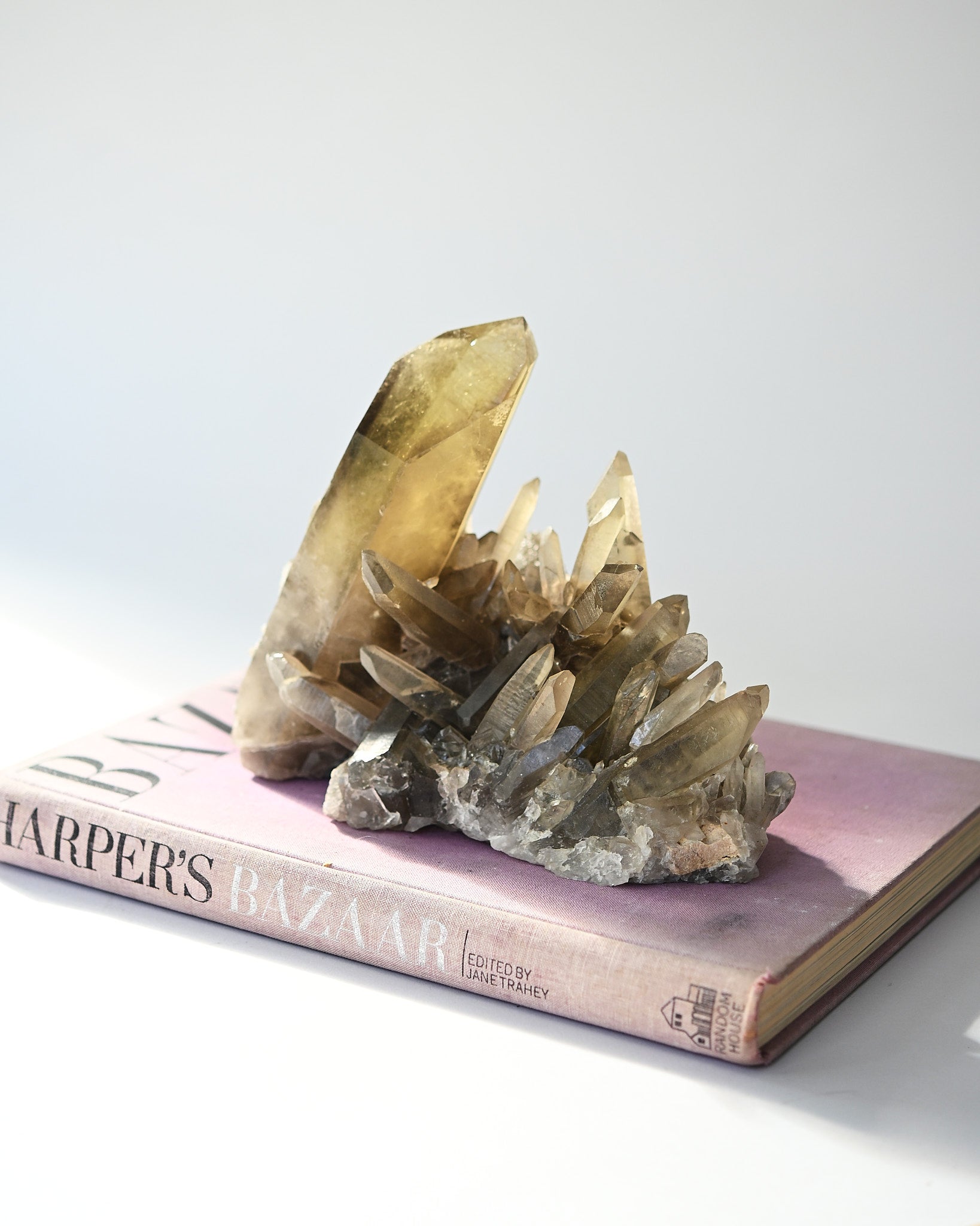 Crystal formation on top of a 'Harper's Bazaar' book with a white background