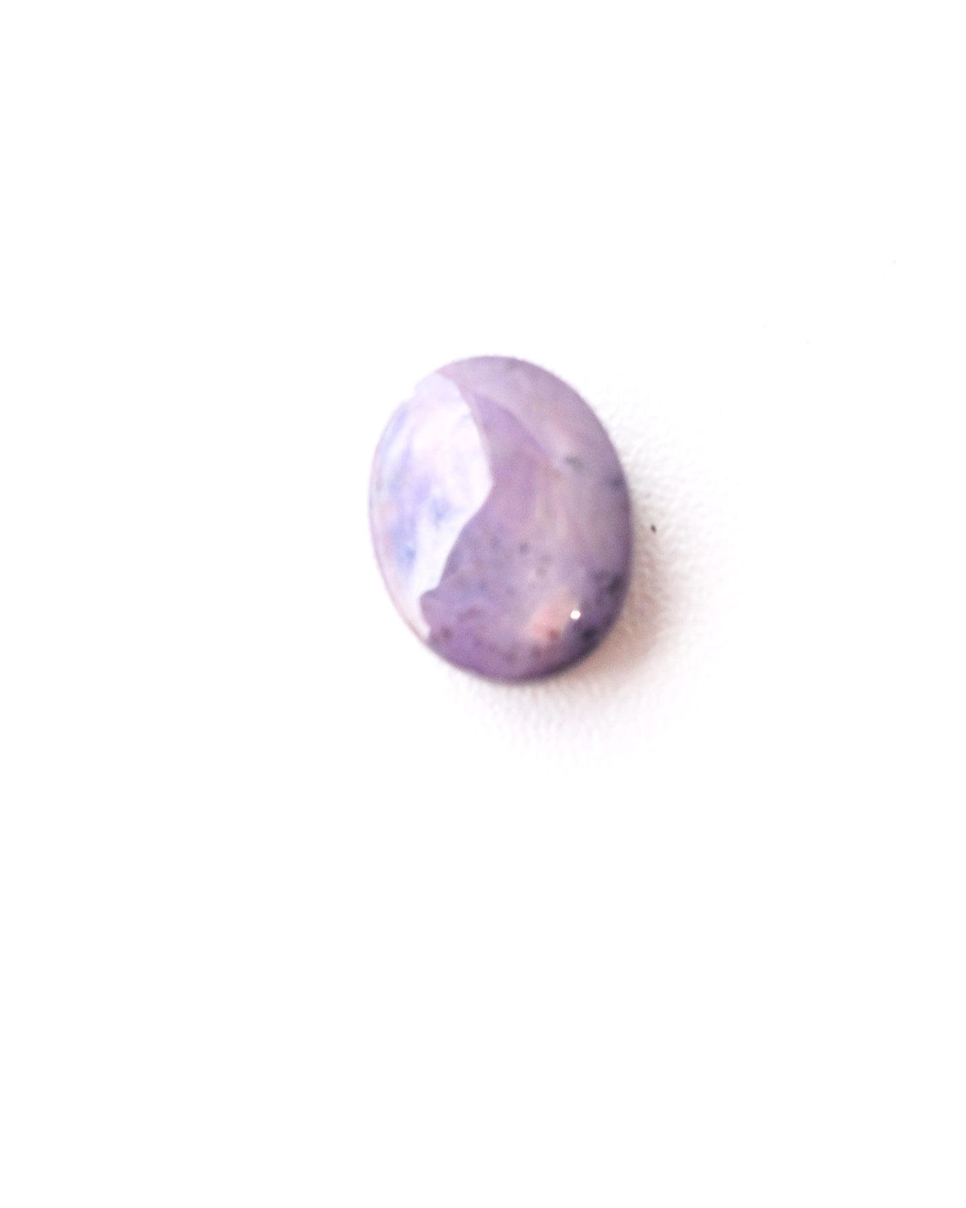 Star sapphire cabochon showing star effect under light