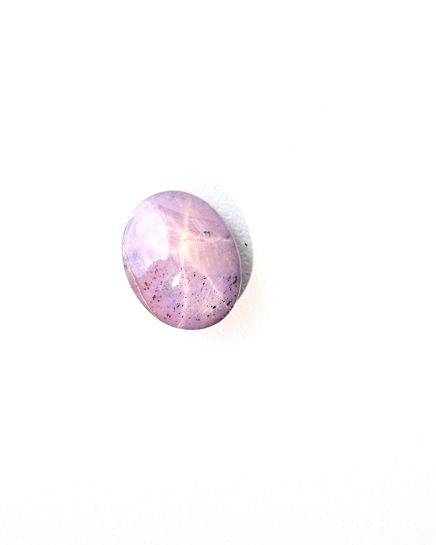 Star sapphire gem showing translucency and purple hue