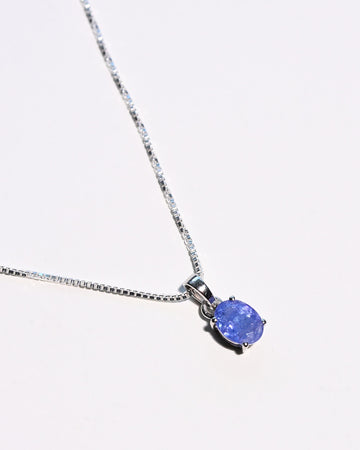 Natural tanzanite pendant necklace close up violet blue gemstone