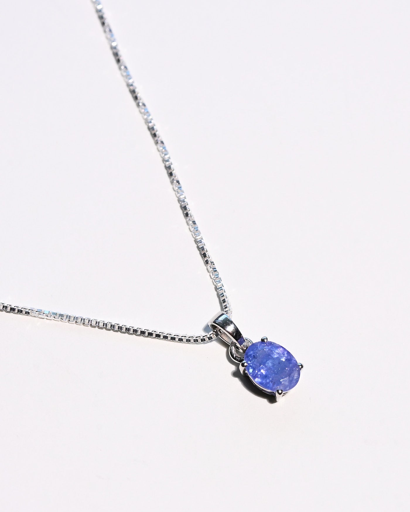 Natural tanzanite pendant necklace close up violet blue gemstone